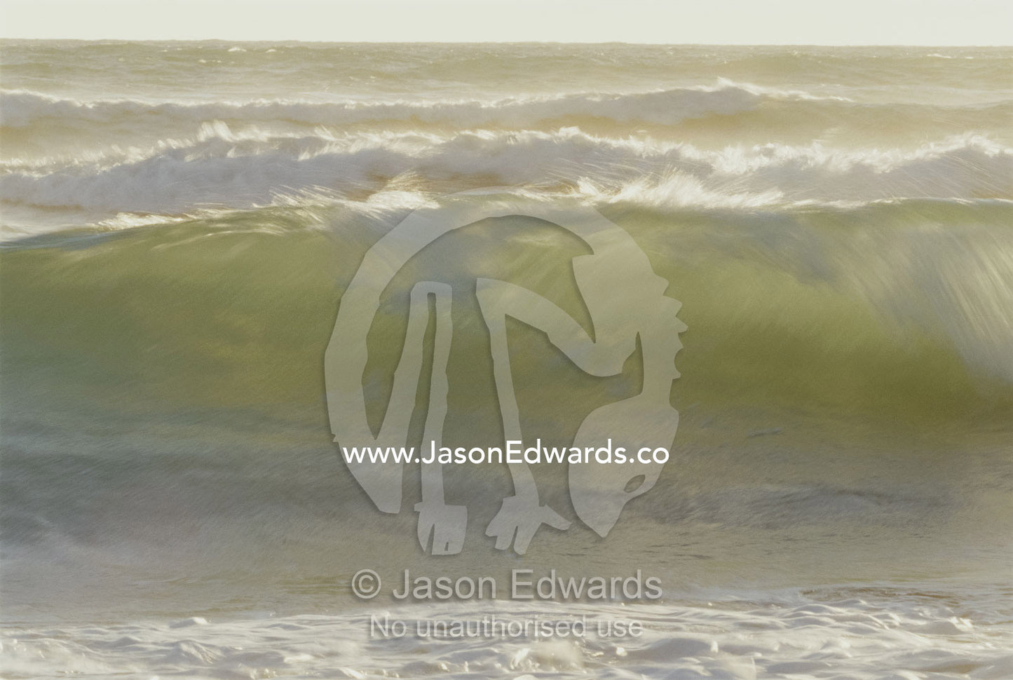 Surf crashes onto a beach at sunset. Younghusband Peninsula, Coorong National Park, South Australia, Australia.