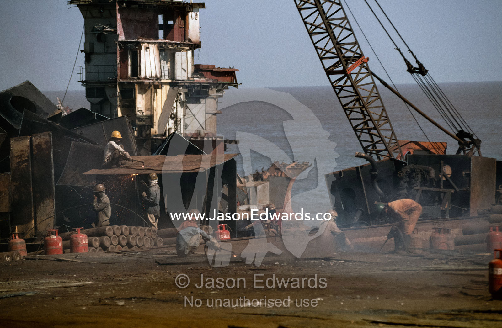 Cutters labor in a world of acrid smoke and explosive gasses. Alang, India.