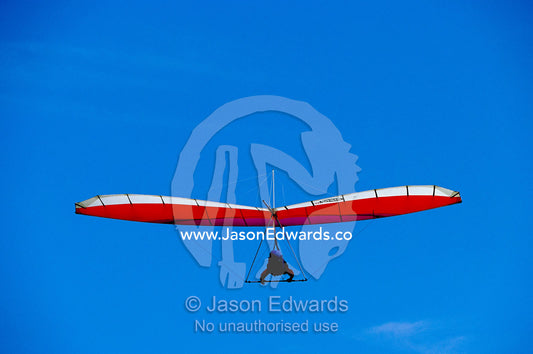 A hang glider in clear blue sky. Merewether, New South Wales, Australia.