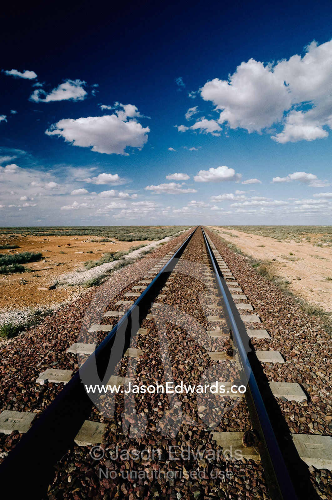 Trans Continental train tracks and clouds on the Nullarbor Plain. Nullarbor Plain, South Australia.
