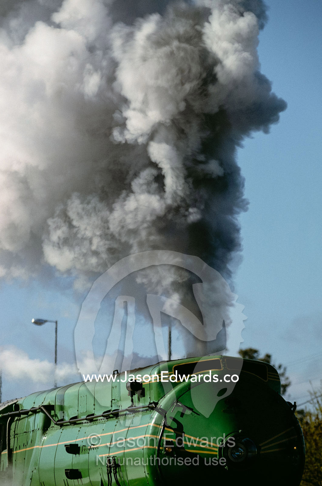 An old steam locomotive belching smoke and steam. Forbes, New South Wales, Australia.