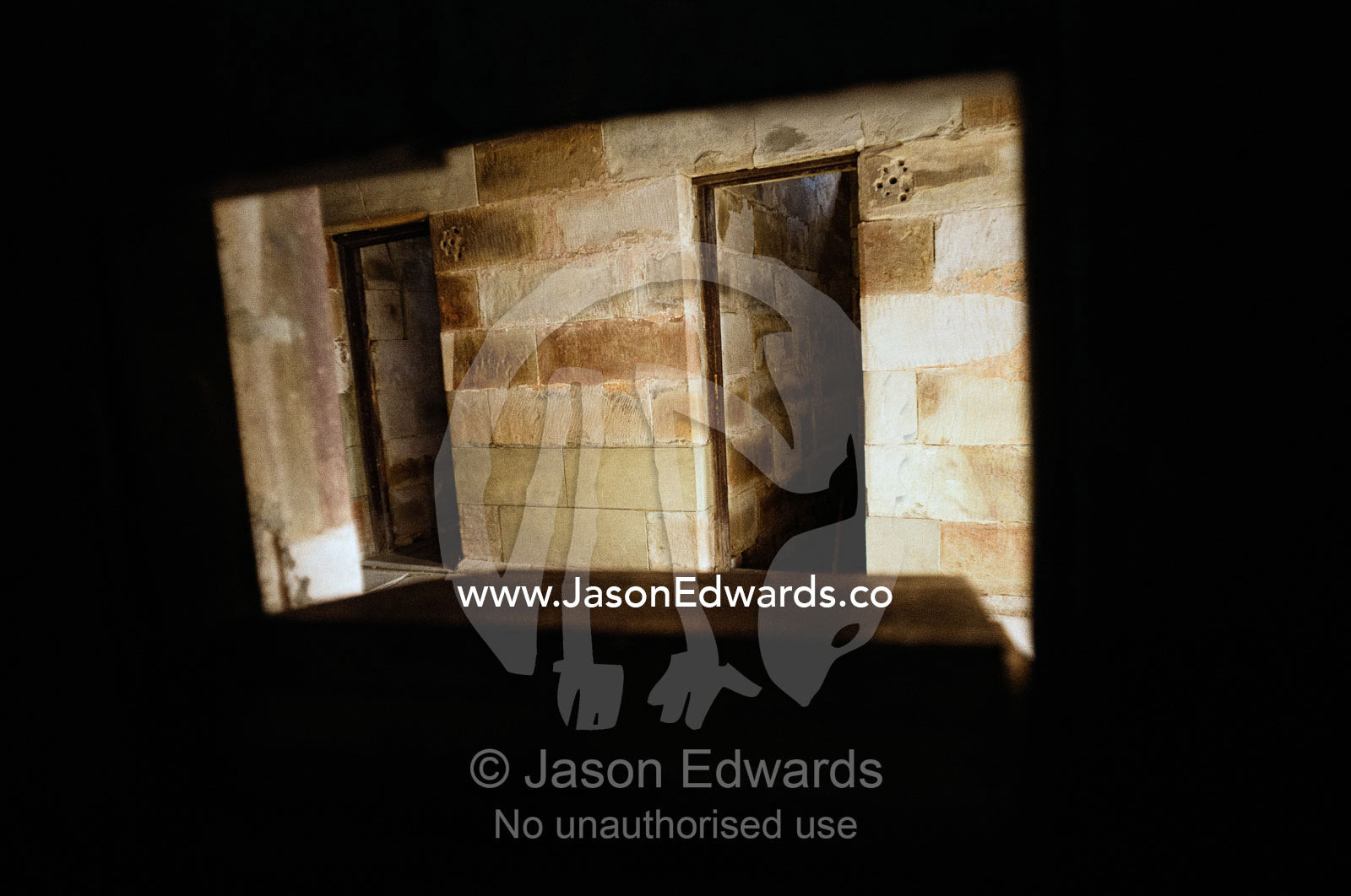 A view through the food tray slot in a prison cell door. Port Arthur Penal Settlement, Tasmania, Australia.