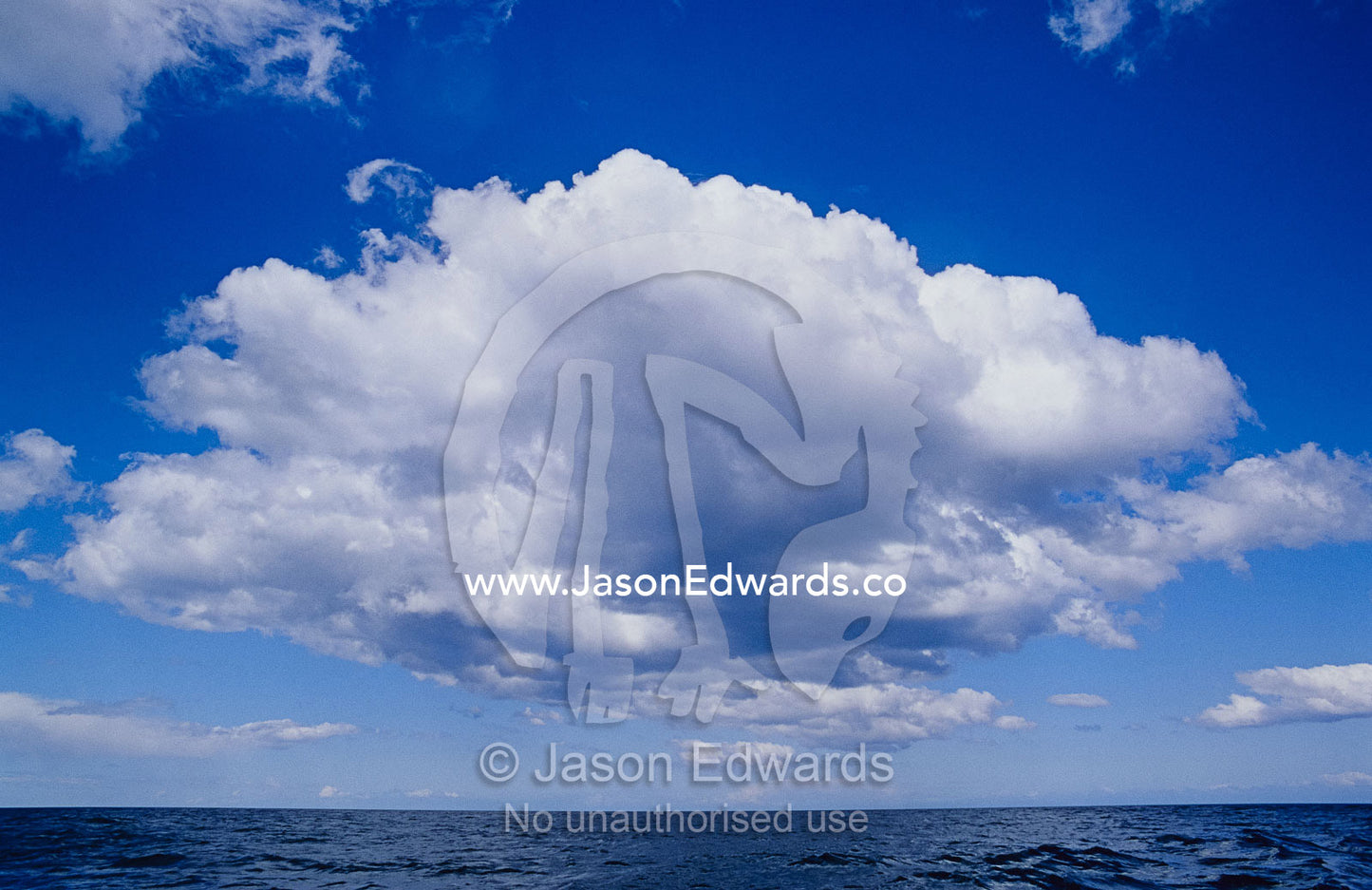 White, fluffy clouds form above the water at Twofold Bay in Australia. Eden, New South Wales, Australia.