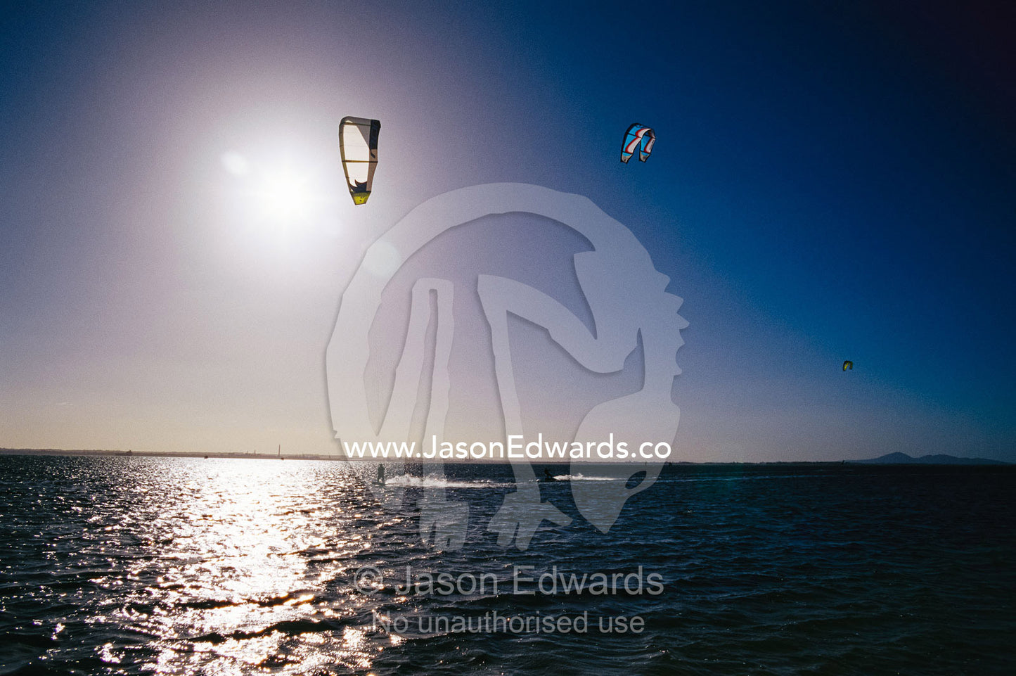 Kite surfers enjoying a day on a windswept bay. Point Henry, Victoria, Australia.