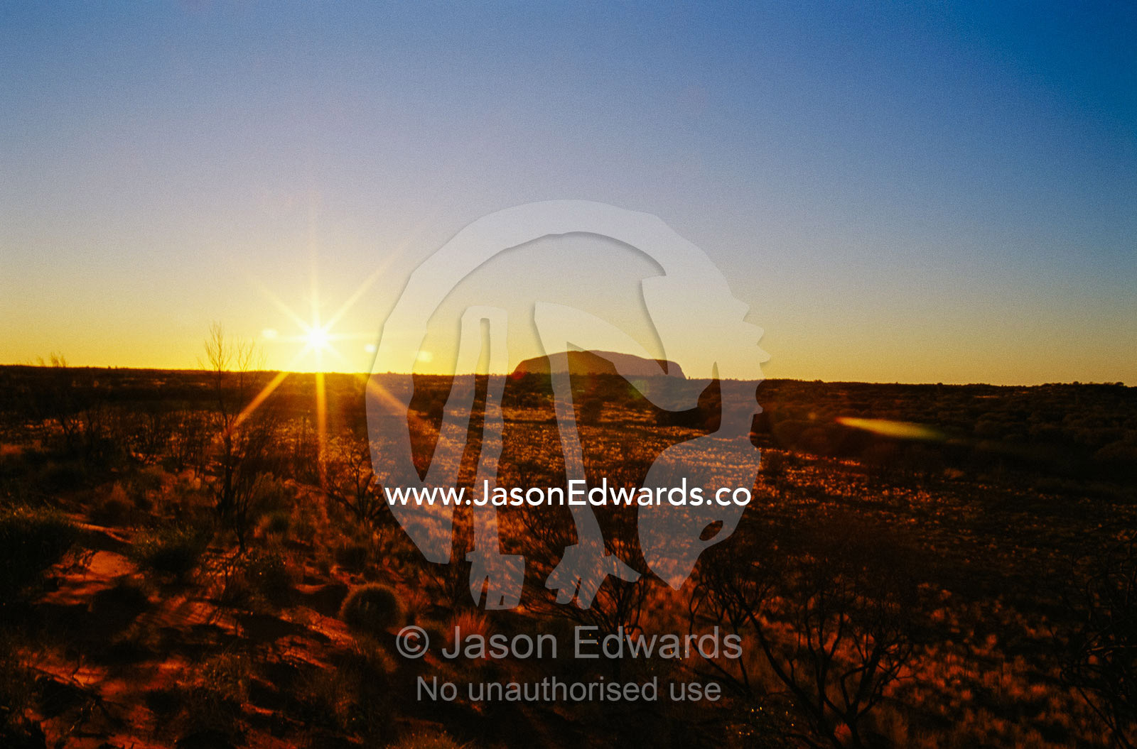 A view of Ayers Rock at sunset. Ayers Rock, Uluru National Park, Northern Territory, Australia.
