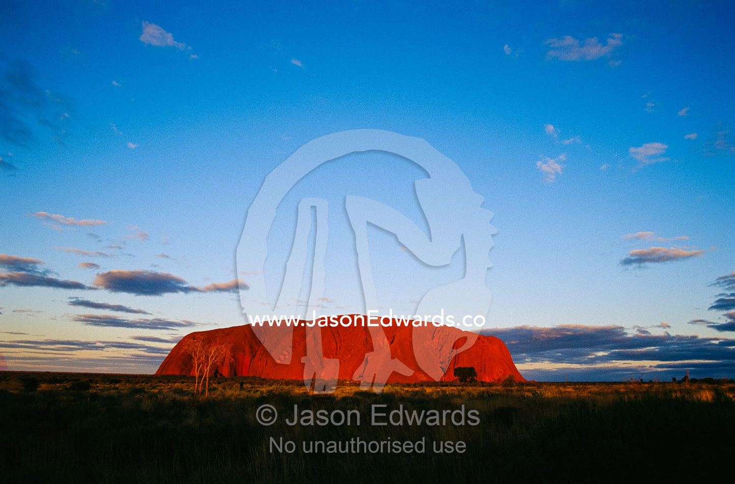 A view of Ayers Rock under a twilight sky. Ayers Rock, Uluru National Park, Northern Territory, Australia.