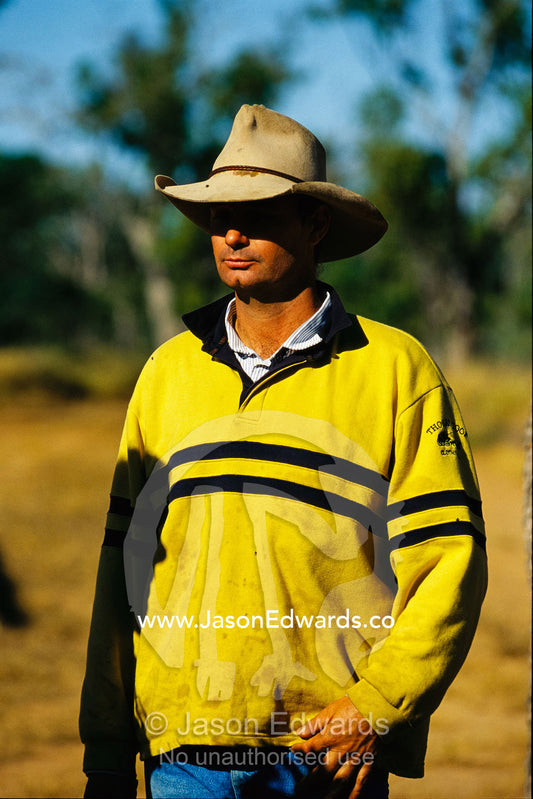 Helicopter pilot weraing a  yellow jacket and worn hat. Epping National Park, Queensland, Australia.