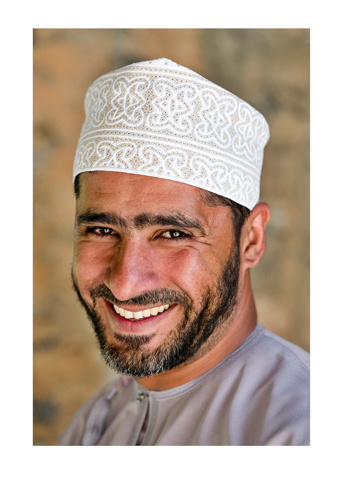 A handsome and happy smiling Muslim man wearing a traditional kuma. Misfat Al Abryeen, Al Hajar Mountains, Al Hamra, Ad Dakhiliyah Region, Sultanate of Oman.