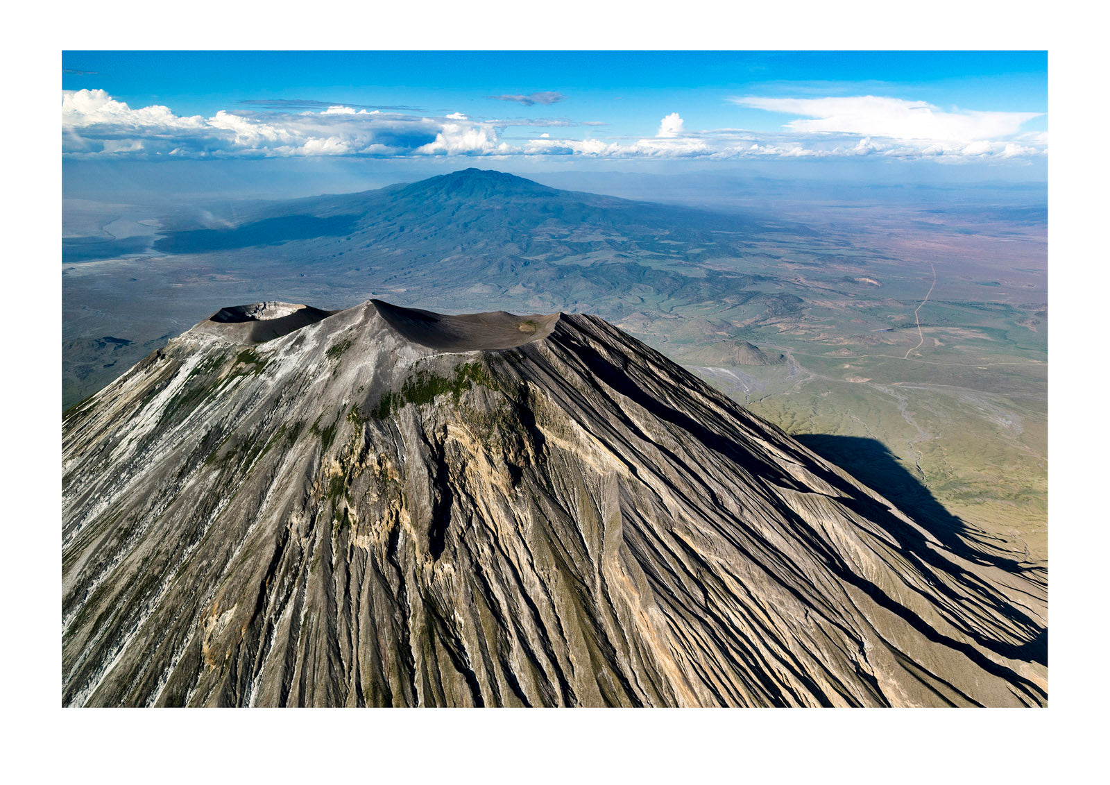 Sweeping lava flows and erosion on the slopes of a volcano caldera cone in the Great Rift Valley. Serengeti National Park, Oldonyo Lengai, Tanzania
