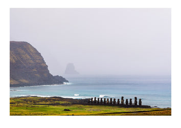 A row of ancient Moai statues greet the surf as it roles onto the rugged coast of Rapa Nui, the world's most remotely inhabited island. Rapa Nui, Easter Island, Chile
