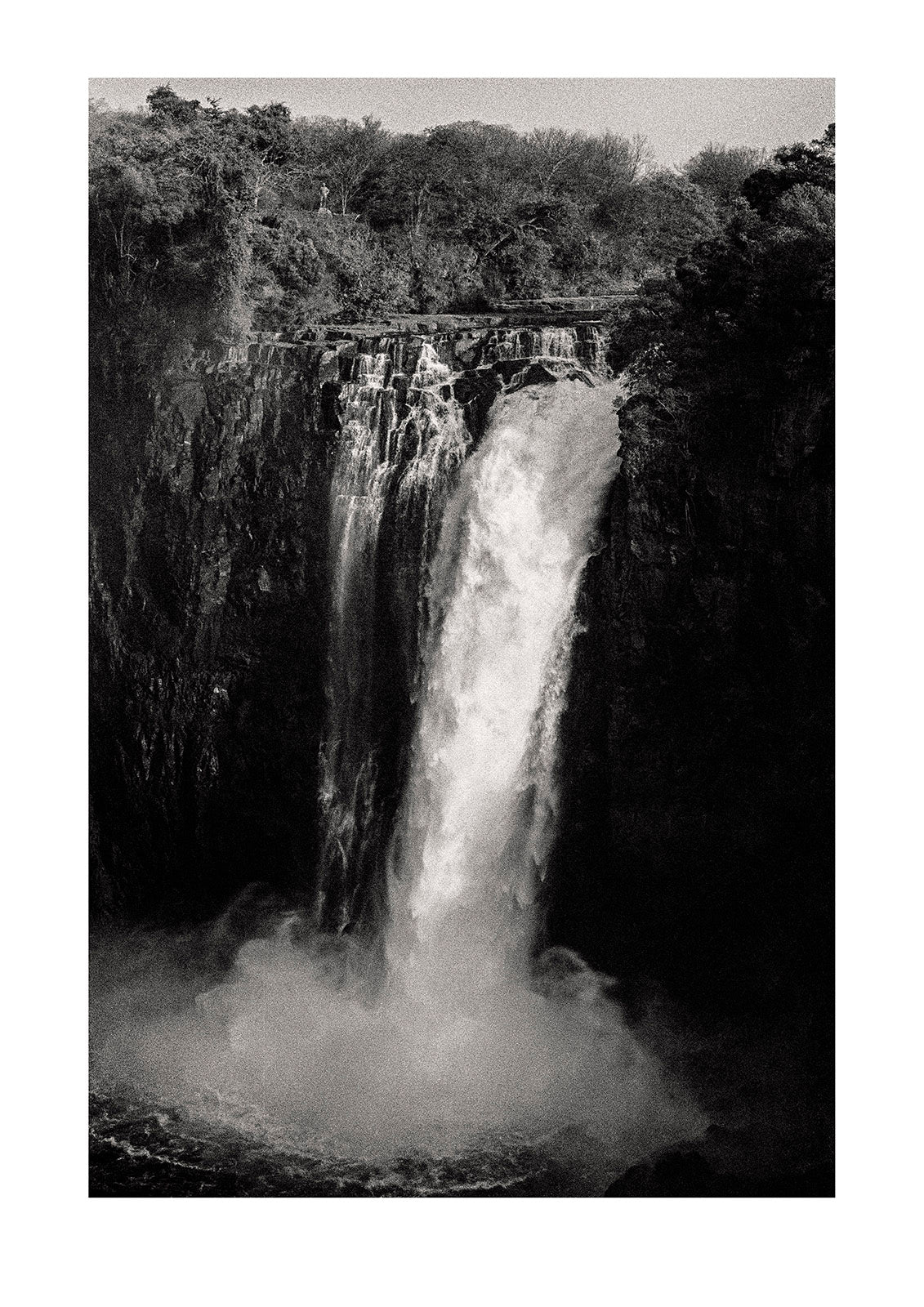 The mighty Victoria Falls cascades into the abyss #1. Captured on Ilford HP5 black and white negative film. Victoria Falls National Park, Zimbabwe.