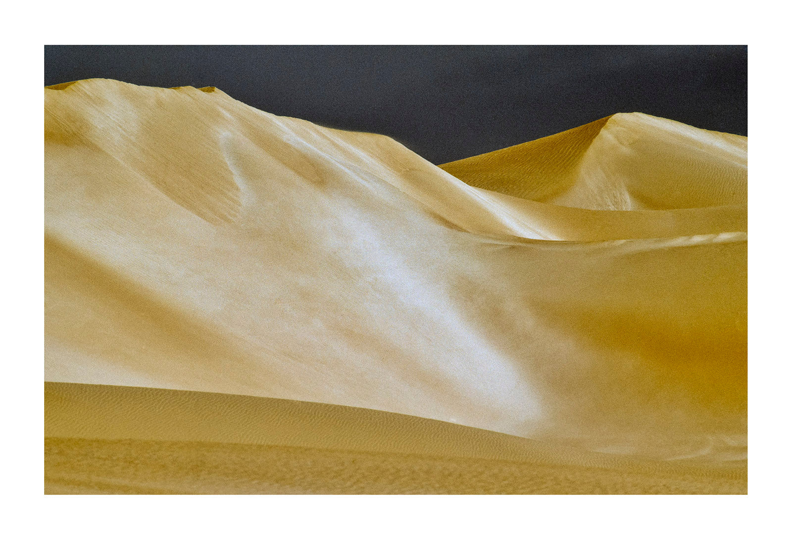Light and shadow on a vast coastal sand dunes shaped by wind. near Cactus Beach, South Australia.